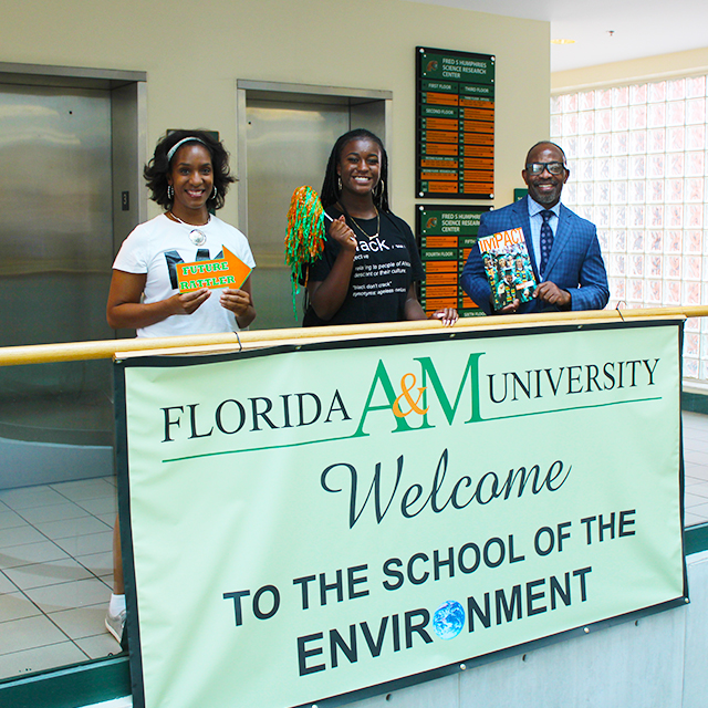 two young adult students holding a map and doing a campus visit 